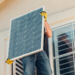 A Man Carrying Solar Panel